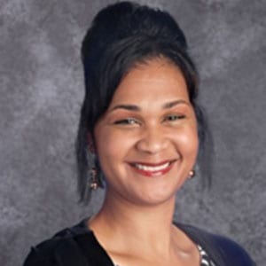 A woman with black hair is smiling for the camera.