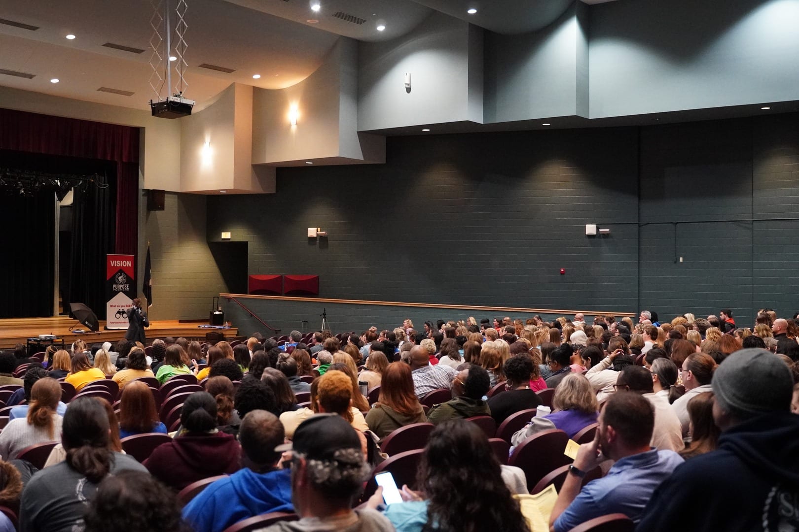 A large crowd of people in an auditorium.