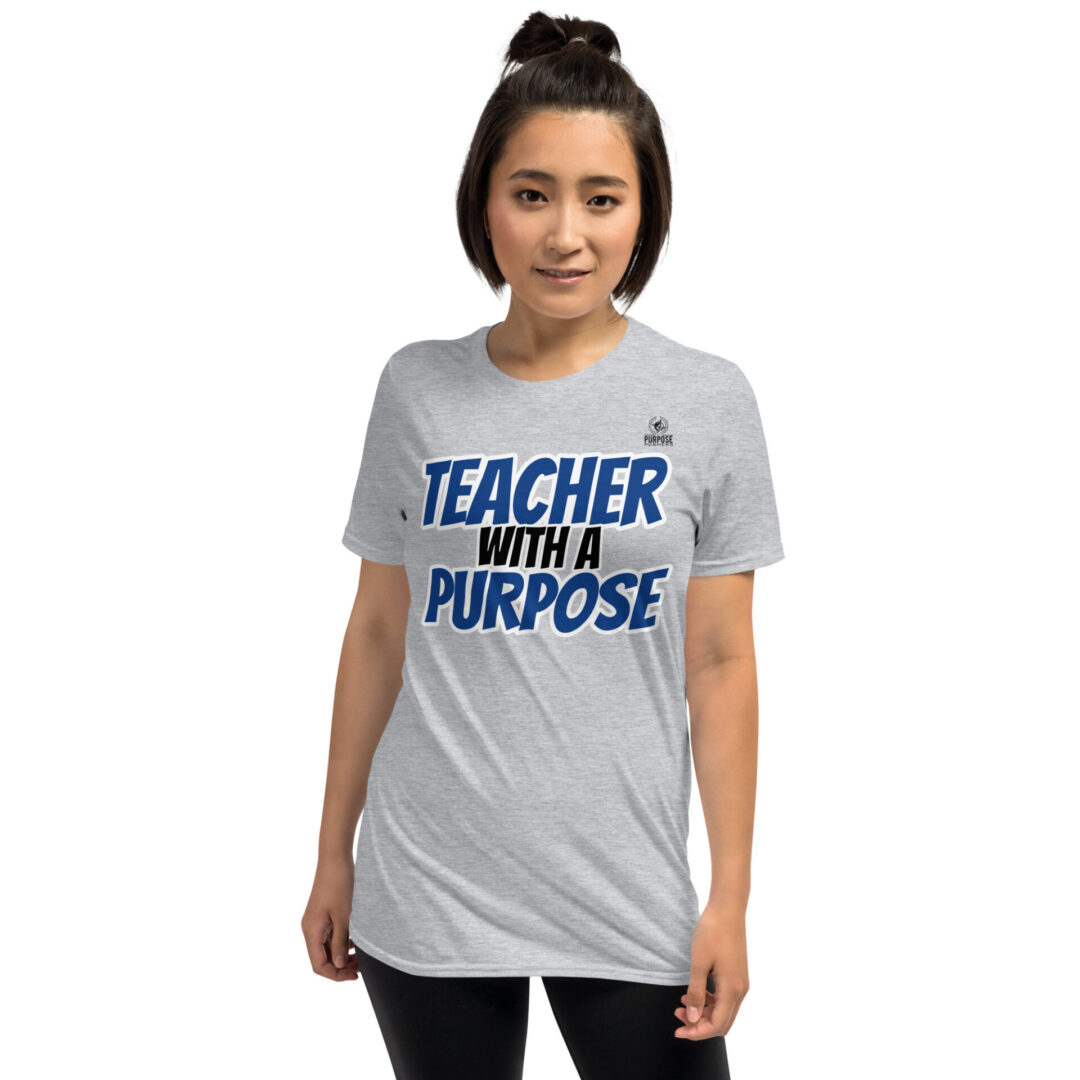 A woman wearing a t-shirt that says teacher with a purpose.